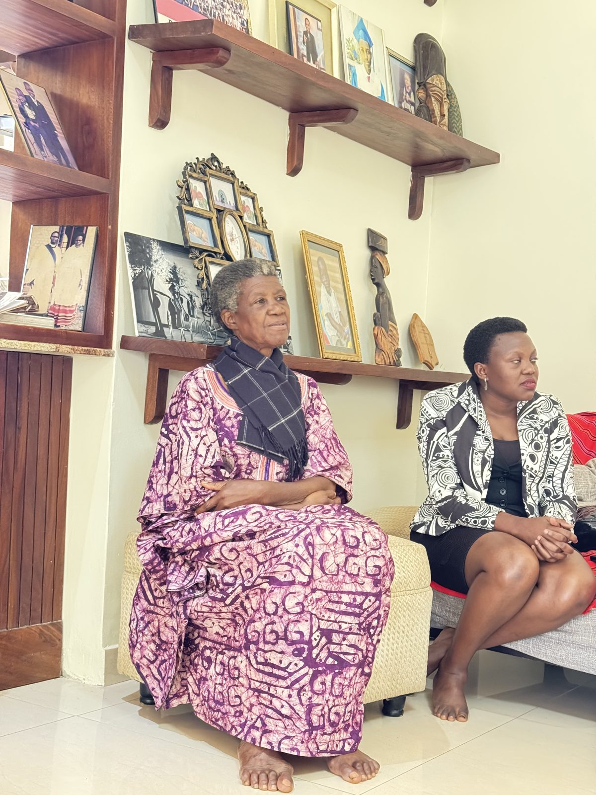 Elder woman with caregiver — Ubuntu Elder Care home visit, Nakawuka, 2025